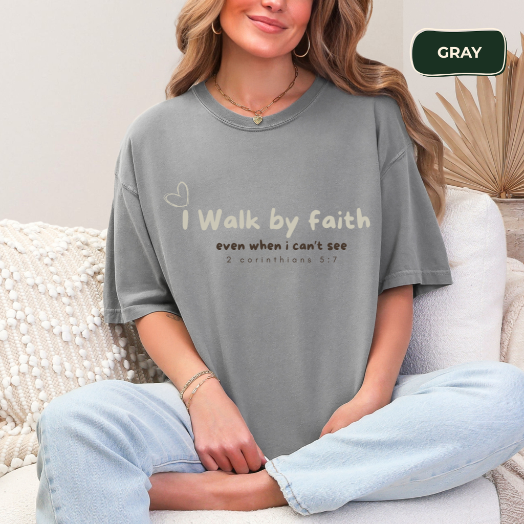 Person wearing a gray t-shirt with text sitting on a couch.